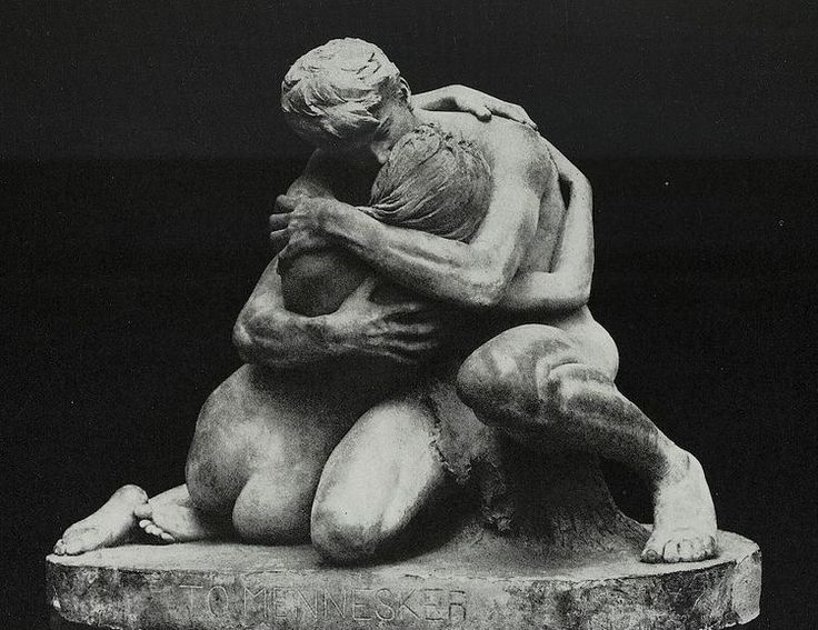 a black and white photo of two people hugging on a stone slab with the word love written below it