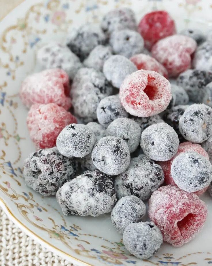 powdered sugar coated berries in a bowl on a table