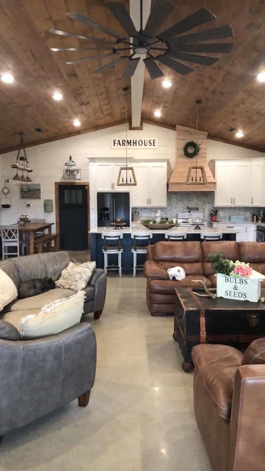 a living room filled with furniture and a ceiling fan in the middle of a room