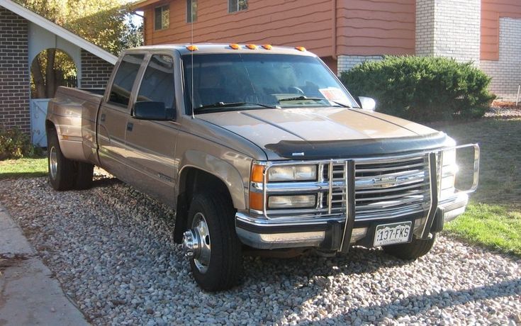 a silver truck parked in front of a house