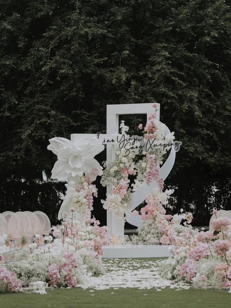 an outdoor wedding setup with flowers and candles