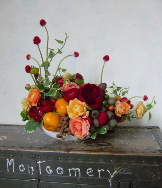 a vase filled with lots of different types of flowers