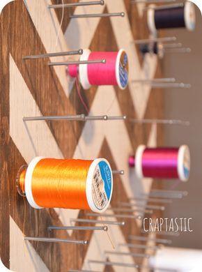 some spools of thread are hanging on a wall