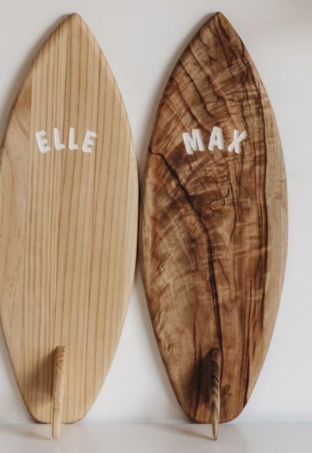 two wooden surfboards with the word'eile max'written on them next to each other