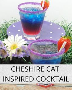 two drinks sitting on top of a purple plate next to some daisies and strawberries