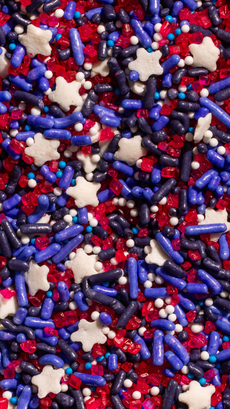 red, white and blue sprinkles are scattered on the surface for decoration