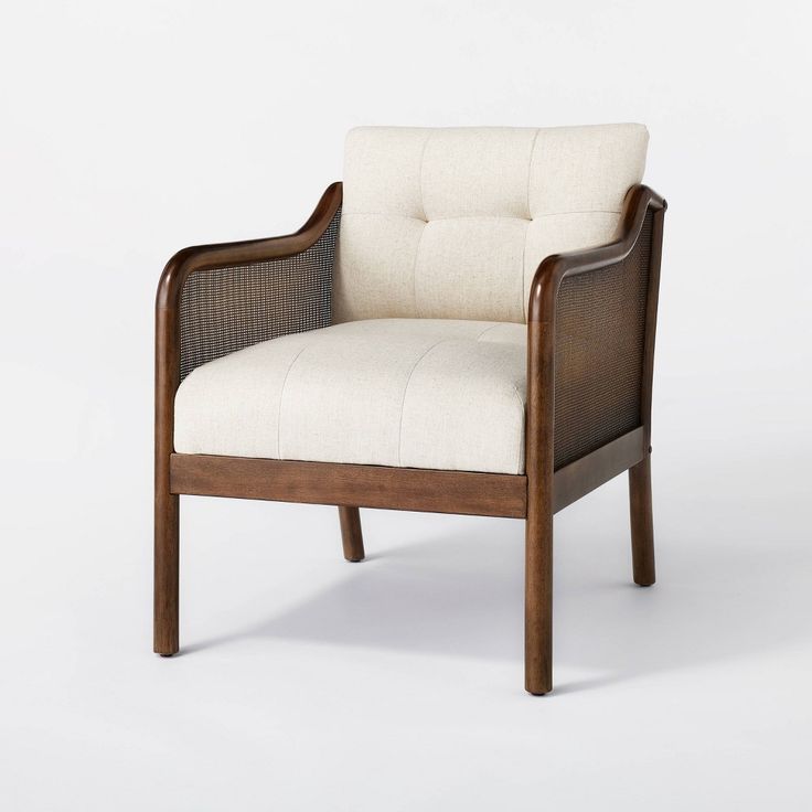 the arm chair is made out of wood and has a white upholstered seat