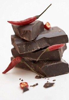 a pile of chocolate with chili peppers on top