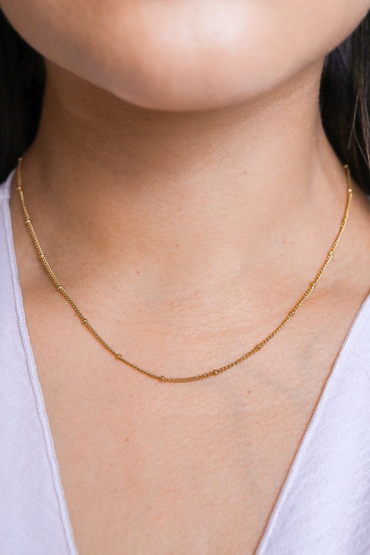 Our Brooke Bead Necklace is designed to make a subtle statement. Featuring dainty balls and a sleek chain, it completes any outfit with effortless grace. Time to give your look a "bauble" boost! All of our jewelry comes with a free jewelry pouch and cloth to keep your pretties safe and clean. Details Color: PVD 18K Gold PlatedMaterial: Stainless SteelSize: 16in + 5cm Extender Care Guide Store in a dry, cool place away from sunlight i.e. Blush & Bliss pouch Gently wipe with a soft cloth after eac Square Neck Bodysuit, Linking Rings, Black Square, Stunning Jewellery, Love Bracelets, Tennis Bracelet, Jewelry Pouch, How To Feel Beautiful, Free Jewelry