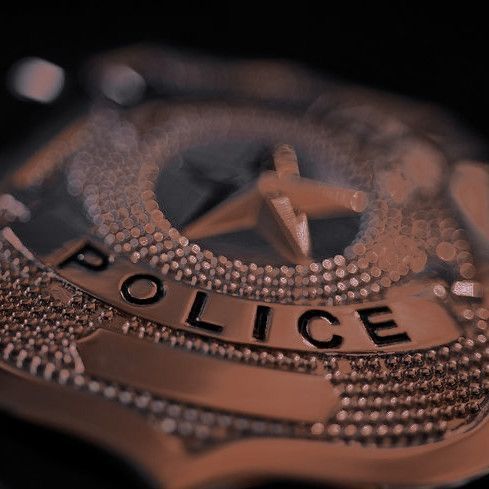 a police badge is shown in this close up photo, with the word police on it