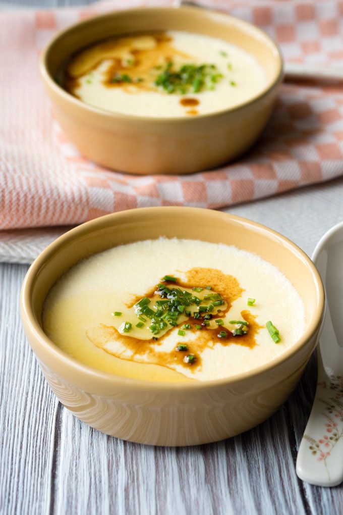 two bowls filled with soup on top of a table