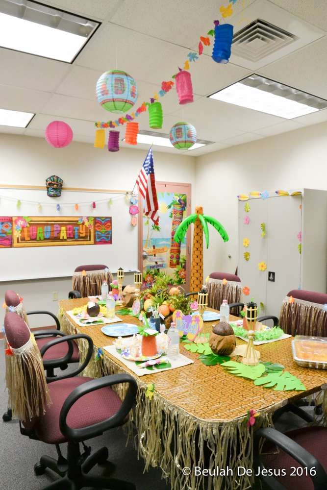 an office decorated for a hawaiian themed party with paper lanterns hanging from the ceiling and decorations on the tables