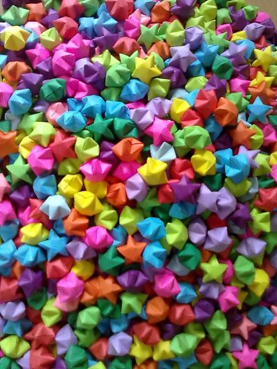 a large pile of colorful origami stars