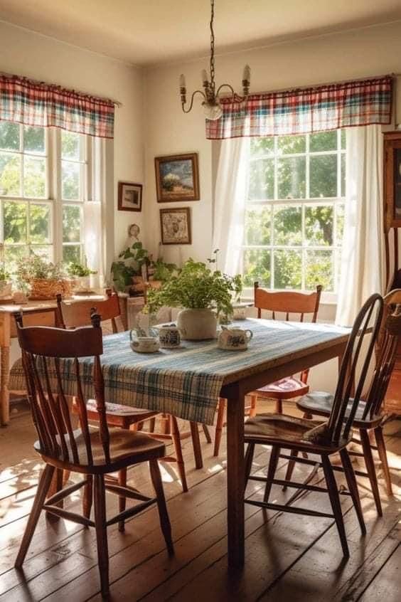 a dining room table with chairs and a potted plant