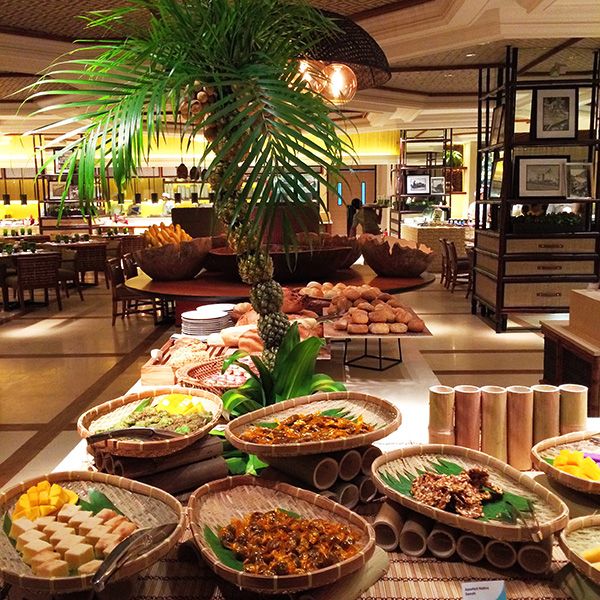 a buffet with many different types of food on the table and in baskets next to each other