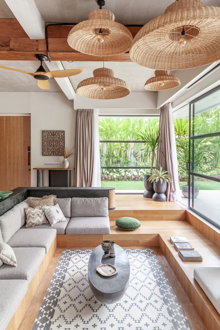 a living room filled with furniture and lots of windows