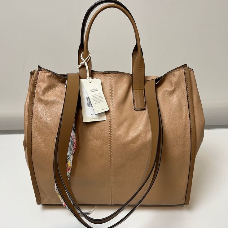 Lucky Brand Dina Leather Tote Bag Outward Facing Seams And A Soft Silhouette Highlight The Versatility Of This Spacious Tote Bag Made From Rich Leather. 10.5" H X 14" W X 5.5" D, 7" Handle Drop, 42" Strap Drop Dual Rolled Top Handles, Optional Crossbody Strap Magnetic Top Closure Interior Has Zip And Slip Pockets Leather Lined Imported Light Brown Hobo Bag For Shopping, Light Brown Shoulder Bag With Handles For Shopping, Luxury Brown Hobo Bag For Shopping, Camel Leather Top Handle Satchel, Chic Camel Shoulder Bag With Leather Lining, Light Brown Tote Hobo Bag For Shopping, Light Brown Hobo Tote Bag For Shopping, Luxury Leather Satchel In Camel, Luxury Leather Camel Satchel