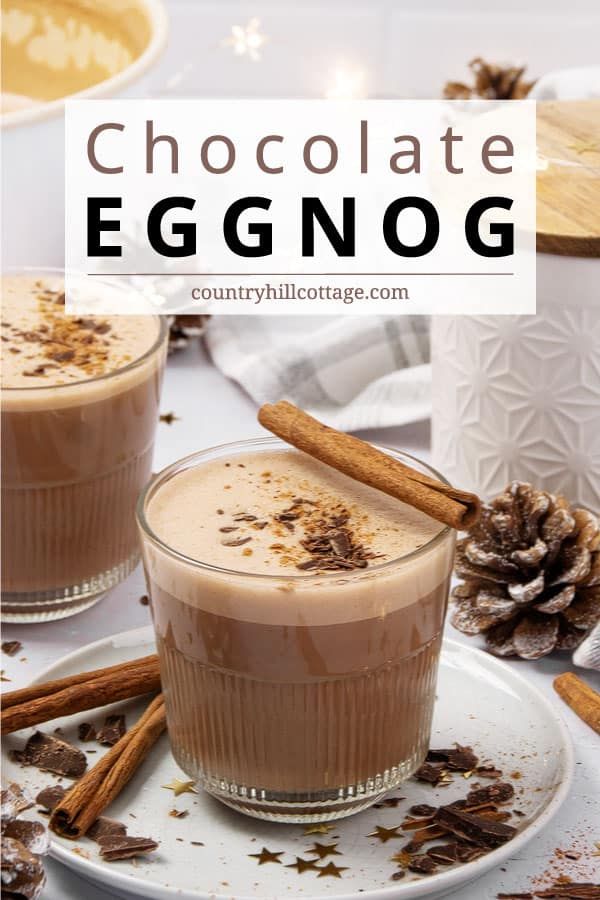 two glasses of chocolate eggnog with cinnamon sticks