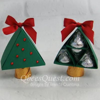 two small wooden christmas trees with red bows