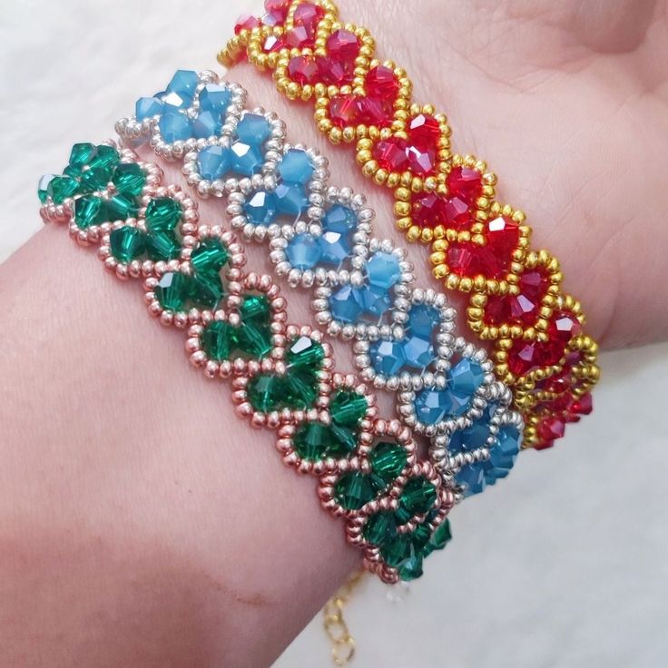 a woman's arm with beaded bracelets on it and beads in different colors