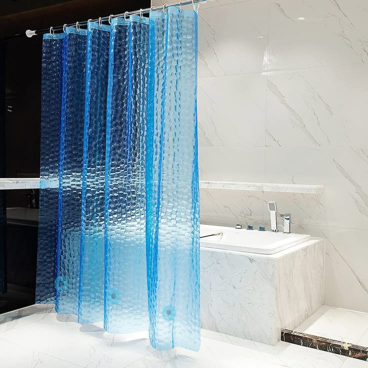 a bathroom with a shower curtain and bathtub