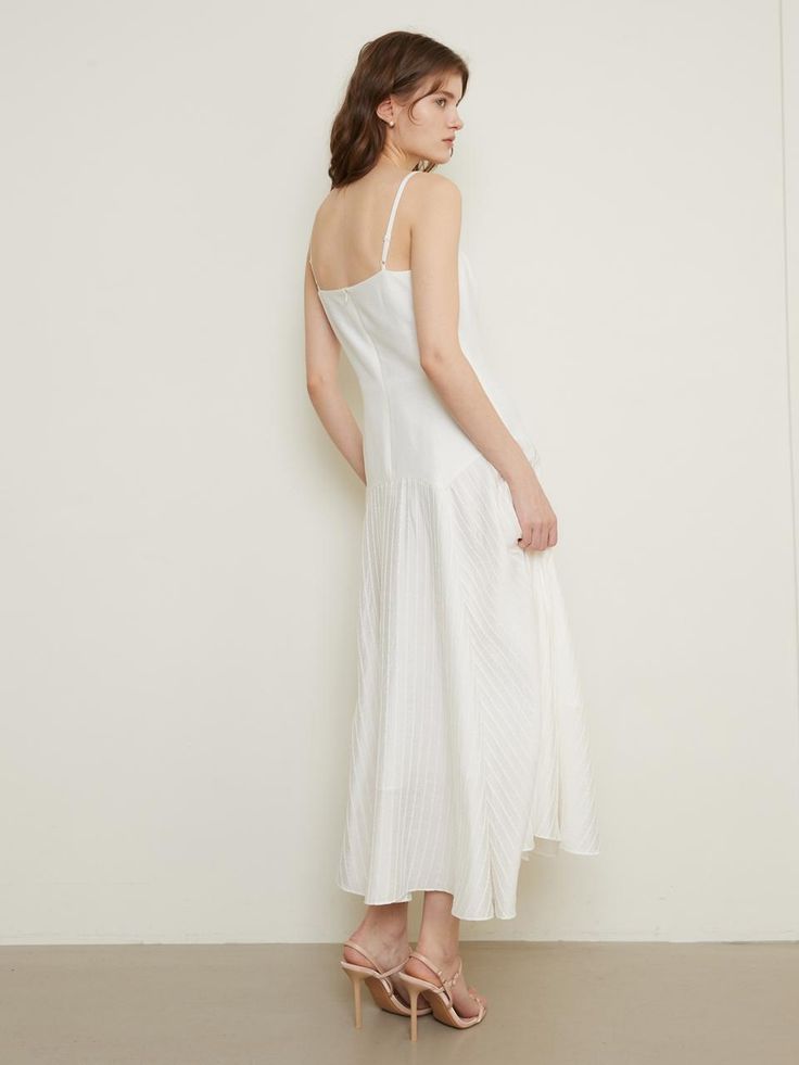 The Camisole Flared Dress exudes a romantic and ethereal charm with its delicate design. This dress features a fitted bodice with a flared skirt, providing a flattering and comfortable fit. Perfect for special occasions, it blends sophistication with a touch of whimsy. - This Camisole Flared Dress is made from lightweight, breathable fabric, ensuring all-day comfort.- The flared skirt adds movement and elegance, making it ideal for twirling.- It has a fitted bodice that enhances the silhouette and provides a flattering fit.- A handmade Cali medal decoration has been attached to the lower right side of the front panel to add a unique point of interest. Flared Dress, Delicate Design, Flared Skirt, A Romantic, Fitted Bodice, Dress White, Flare Skirt, Right Side, Flare Dress