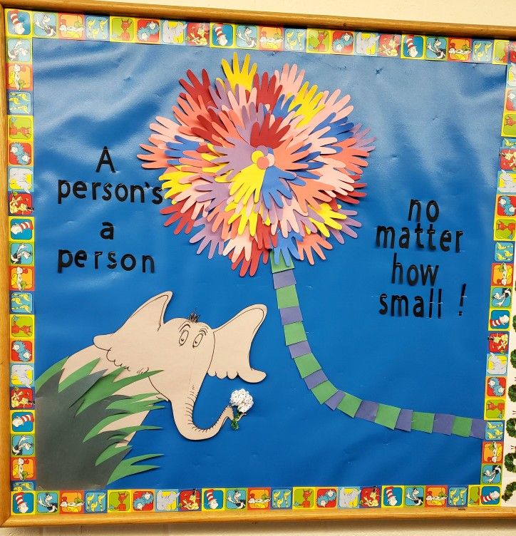 a bulletin board with an elephant holding a flower and saying no matter how small it is