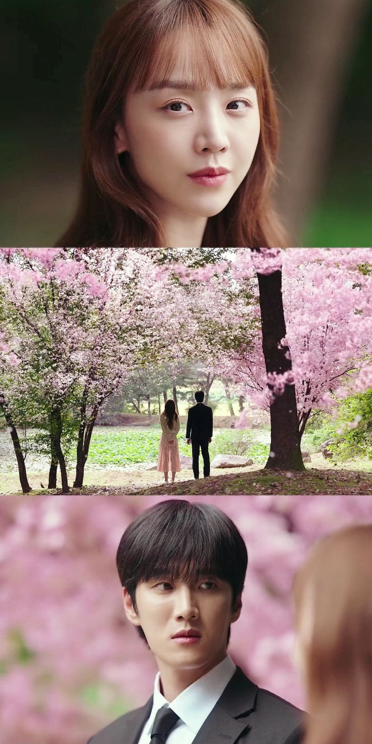 two people standing next to each other in front of pink flowers and trees with one person looking at the camera