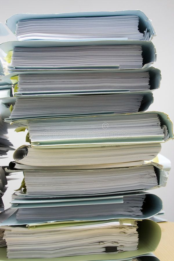 a stack of papers sitting on top of a table next to a computer mouse and keyboard