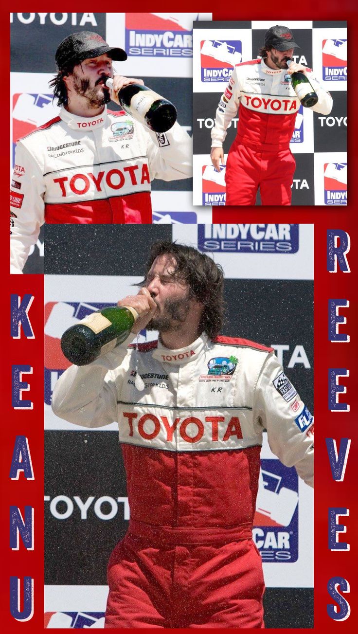 a man drinking from a bottle while wearing a racing suit