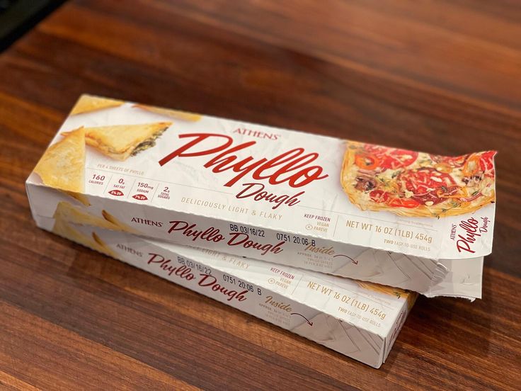 three boxes of pizza sitting on top of a wooden table