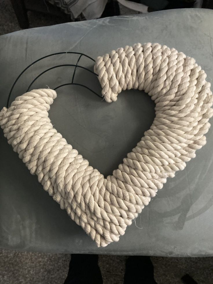 a heart made out of rope sitting on top of a table