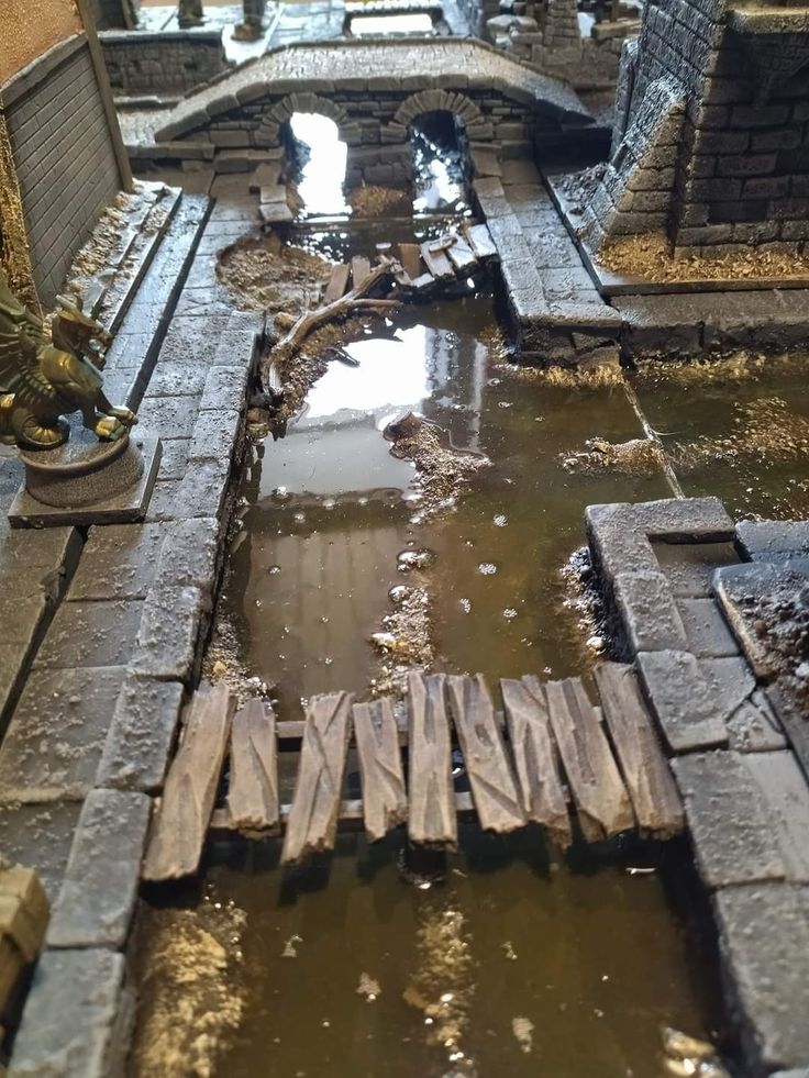 a miniature model of a bridge with water running through it