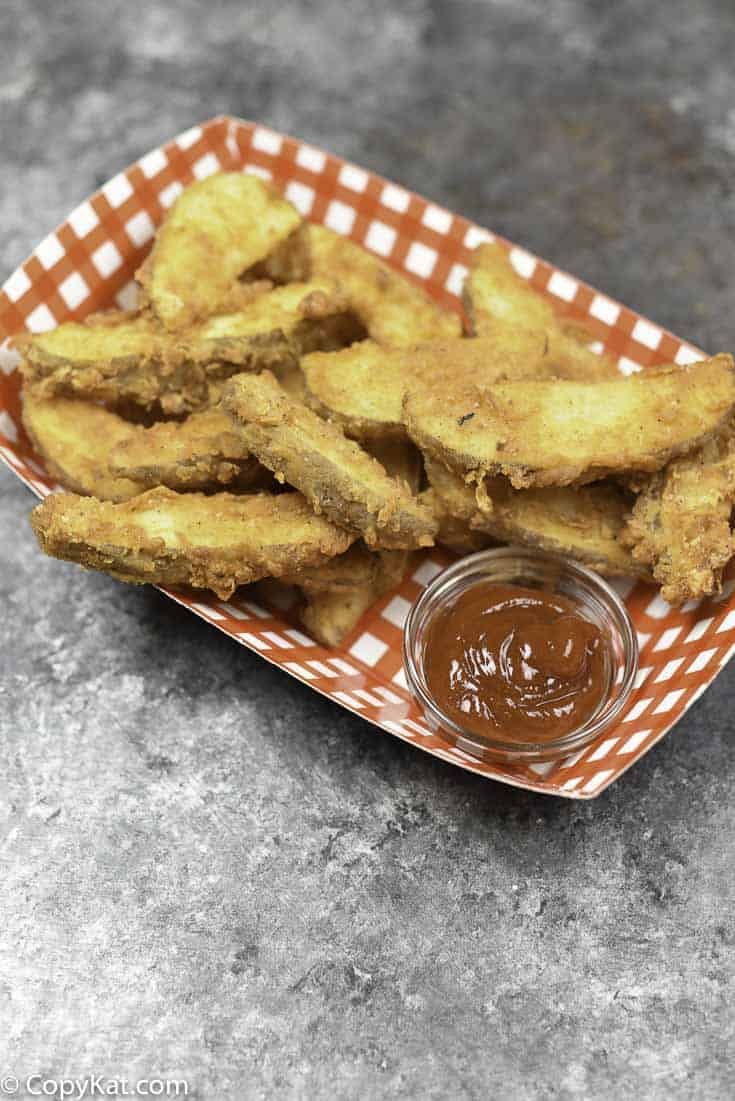 fried chicken sticks with dipping sauce on a plate