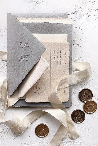 the wedding stationery is laid out and ready to be put into their guests'bags