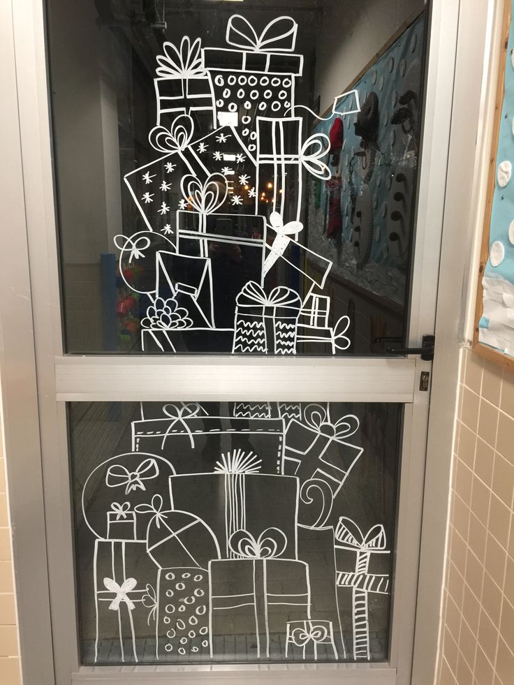 a drawing on the glass door of a store with presents and gifts drawn on it