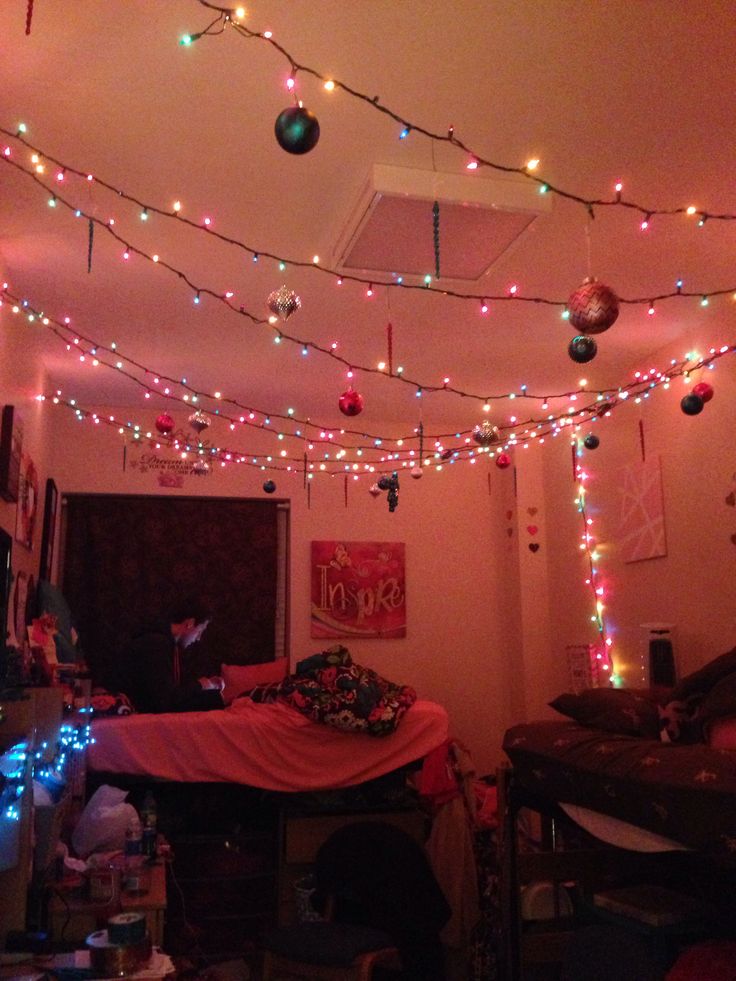 a room filled with lots of christmas lights and decorations hanging from the ceiling above it