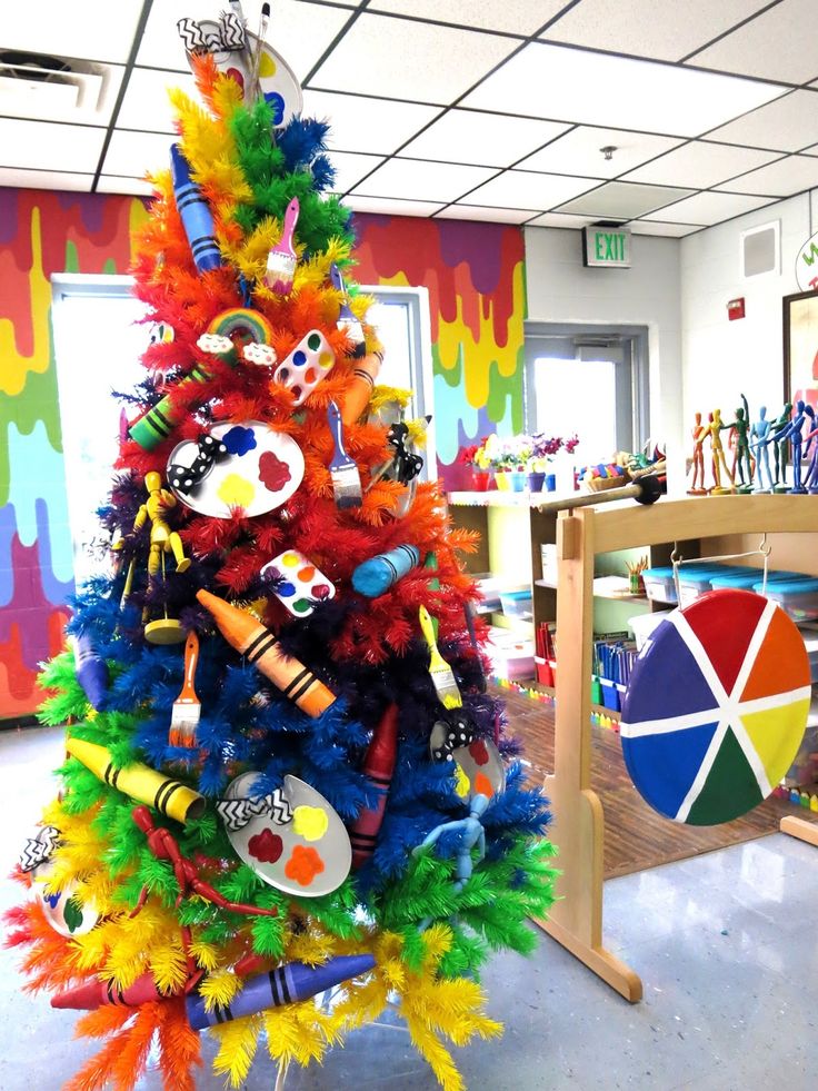 a colorful christmas tree in an office decorated with markers and crayon pencils