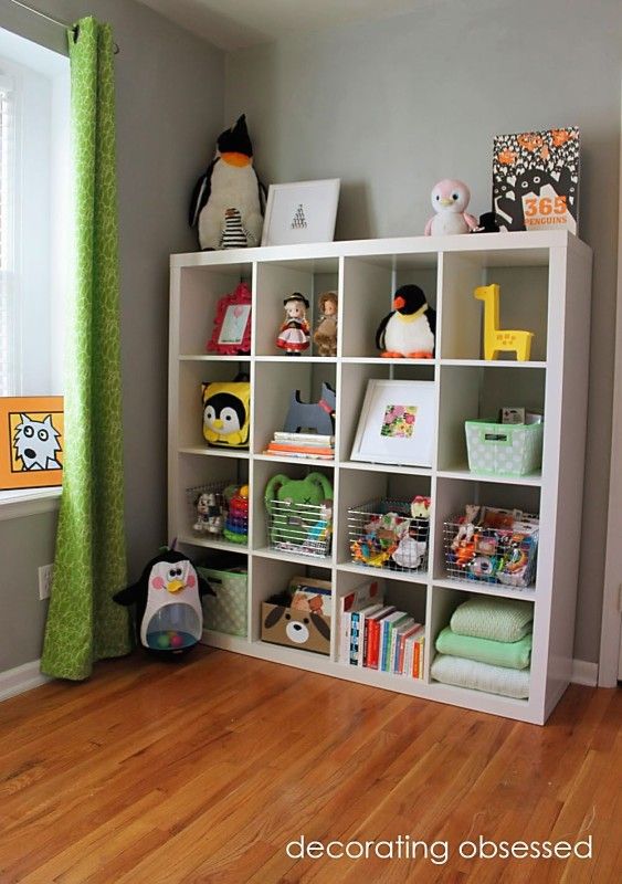 a child's room with bookshelves and toys