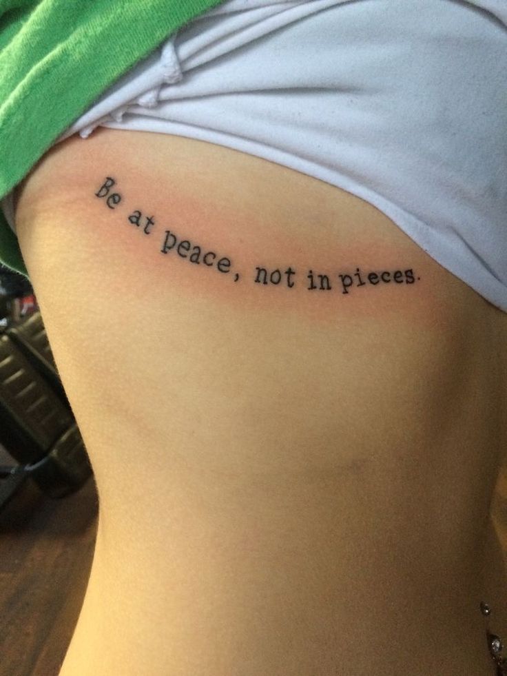 a woman with a tattoo on her stomach saying, no at peace, not in pieces