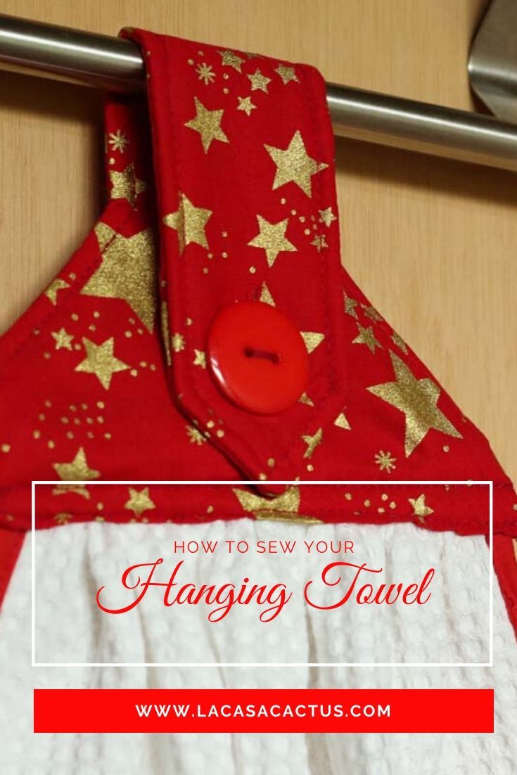 a red and gold christmas towel hanging on a rack with the words how to sew your hanging towel