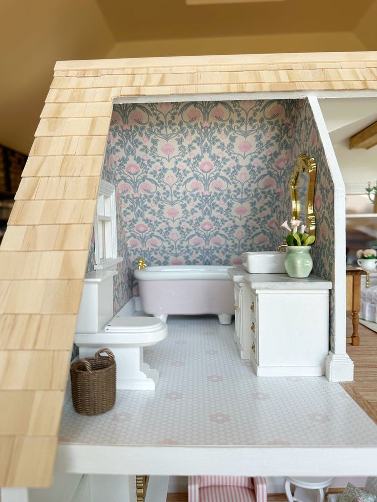 a doll house with a bathtub, toilet and sink