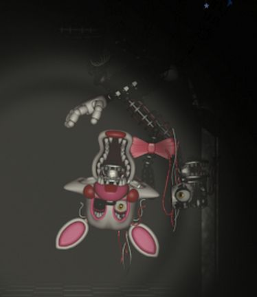 a pink and white stuffed animal hanging from the ceiling in front of a black background