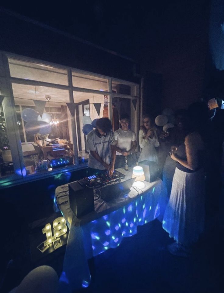 a group of people standing around a table