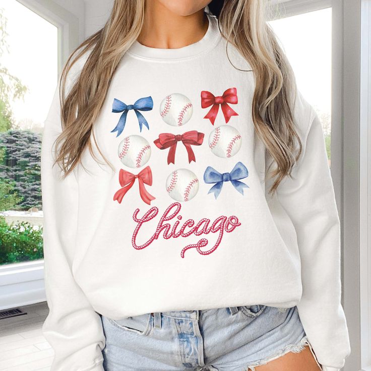 Stand out in style with this custom sweatshirt featuring a trendy bow and baseball design. Add a personalized touch with your team's name and colors. Perfect for showing off your team spirit (and fashion sense). Score a home run with this one-of-a-kind top! Design is Printed Direct to Garment. Long Sleeve T-shirt For Baseball Game Day, Game Day Fan Apparel Tops With Crew Neck, Game Day Sports Fan Crew Neck Top, Sports Fan Crew Neck Top For Game Day, Game Day Fan Apparel Long Sleeve Sweatshirt, Long Sleeve T-shirt For Baseball Season Game Day, Team Spirit Sweatshirt With Team Name For Baseball Season, Varsity Sweatshirt For Baseball Season, Varsity Style Sweatshirt For Baseball Season