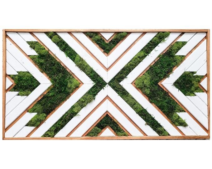 a wooden frame with moss growing on the side and an arrow pattern in the middle