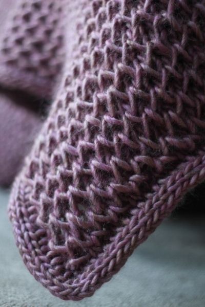 a close up view of a purple knitted sweater