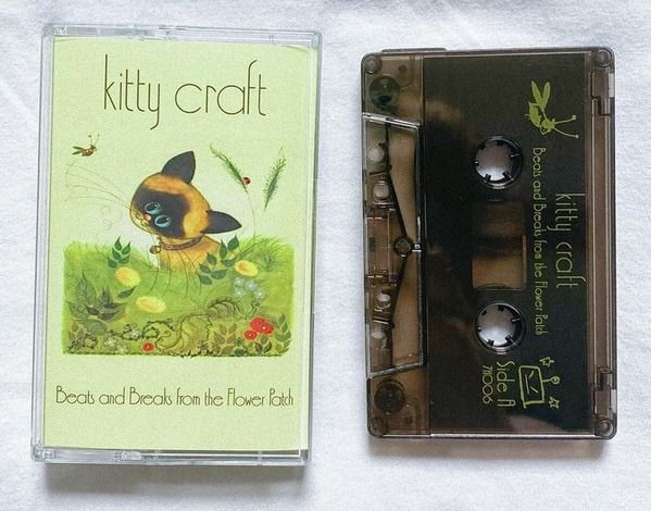 an old cassette is next to a book about kitty craft and the cover has a cat on it