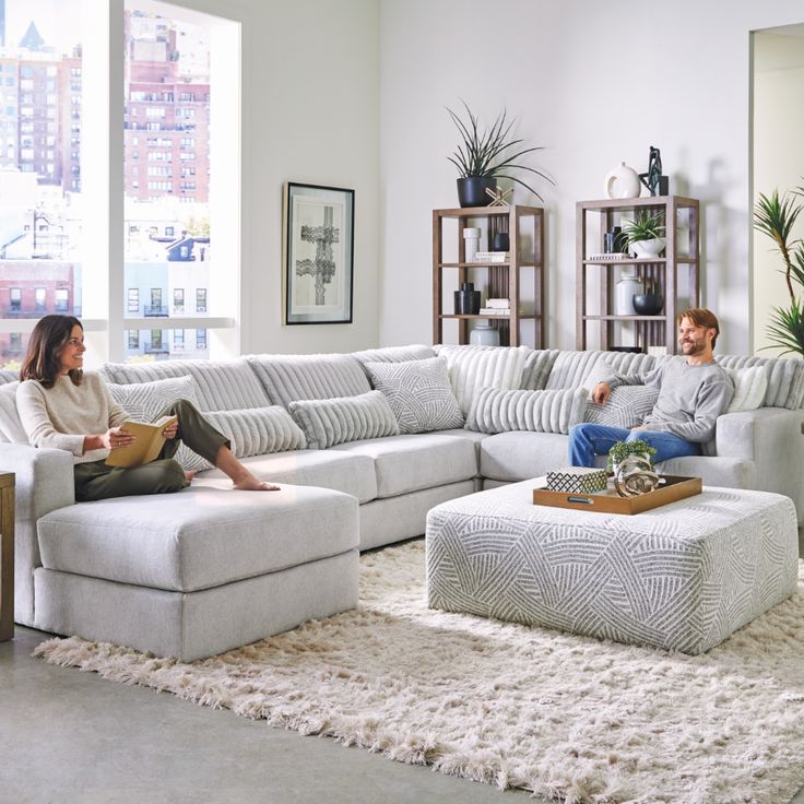 a man and woman sitting on a couch in a living room