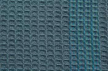 a blue and green textured fabric with small squares on the bottom, as well as lines